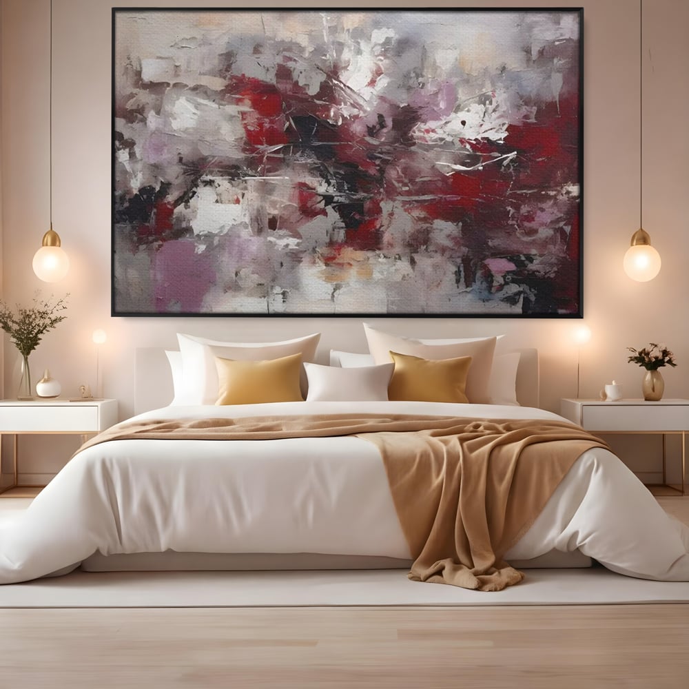 Tablou canvas cu pictura abstracta cu pete rosii, in rama de aluminiu negru, pe perete intr-un dormitor